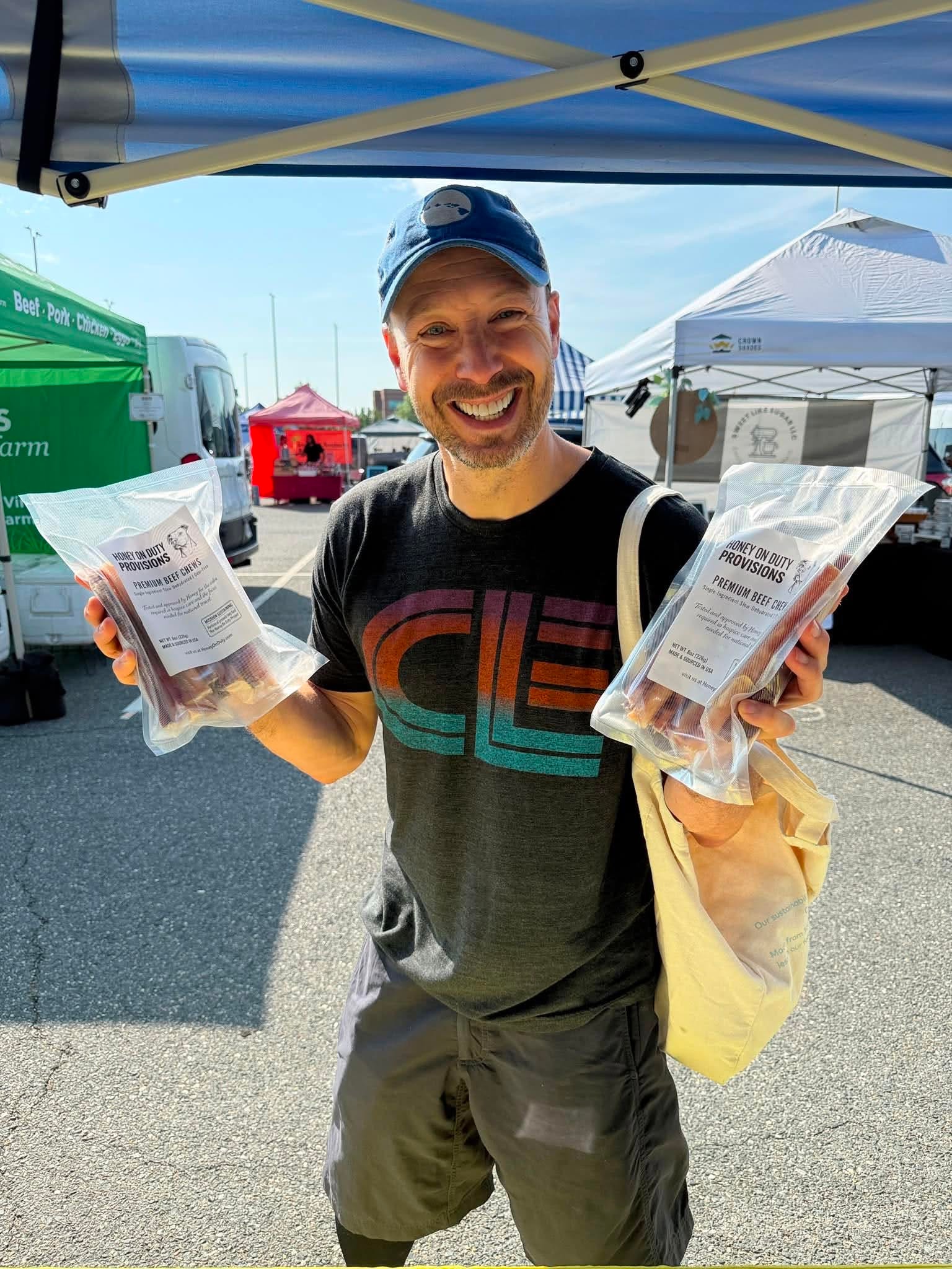 Happy customers at a Honey's Dog Treats market booth