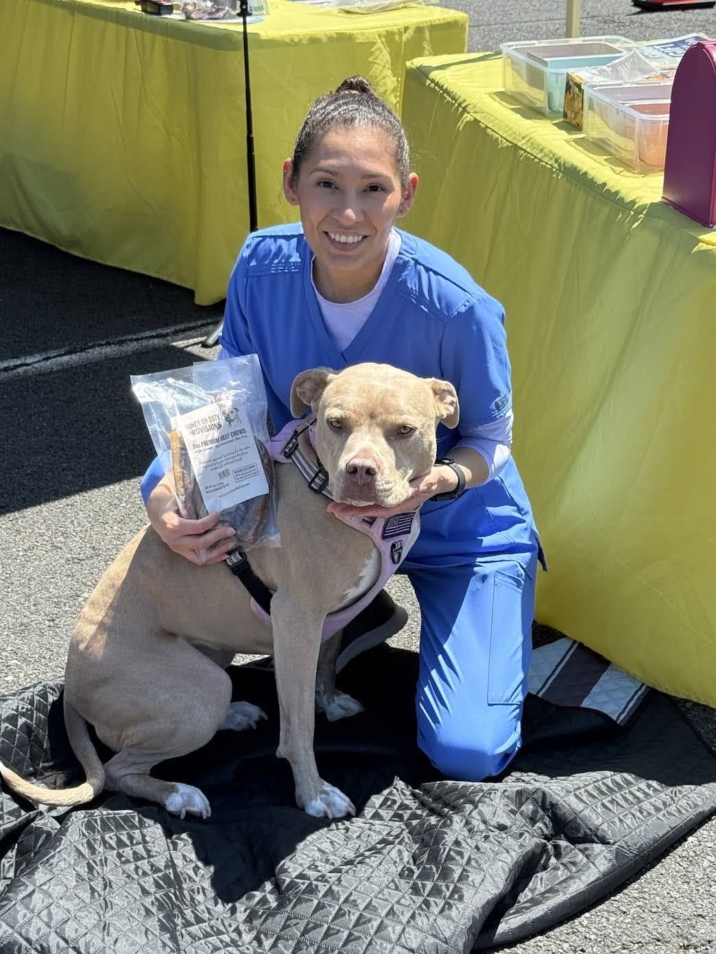 Healthcare worker with her dog holding Honey's Dog Treats